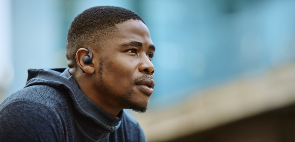 Male wearing Mixx AirFlow Open Earbuds
